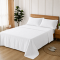 White 100% pure linen bed sheet set made up on a bed